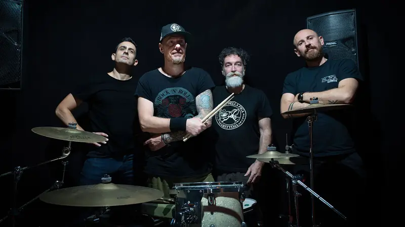 The four members of Climax behind the drum kit